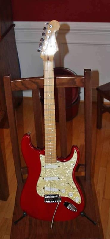 2000 Fender American Deluxe Stratocaster Ash body with Maple Fretboard. Crimson Transparent Red. Perloid dots with Lace Sensor pickups. Pickgurad has been changed to white. Comes with period correct fender hard shell case and original perloid pickguard. image 1