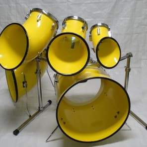 North drum set in yellow with 6'',8''10'' toms a 14'' floor tom and a 22'' bass drum with rack image 1