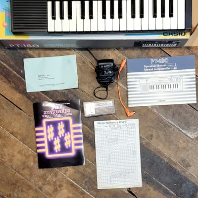 Casio PT-180 32 Mini Key Keyboard with 2 Rom Packs and power supply from '87