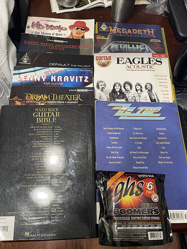 Guitar tab books and 6 sets of strings Reverb