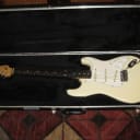 used 1987 Squier by Fender E Series Japan Stratocaster Contemporary Series - Aged Artic White (Creme) +Trem bar & used FREEDOM HSC  (orig locking tremolo +nut were taken off - NOT included) Regular Tremolo on, Truss Rod has issues (read description)