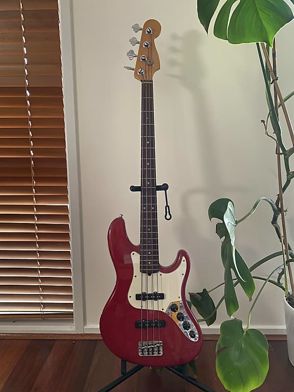 Fender American Deluxe Jazz Bass with Rosewood Fretboard 1999 Crimson Red Transparent image 1