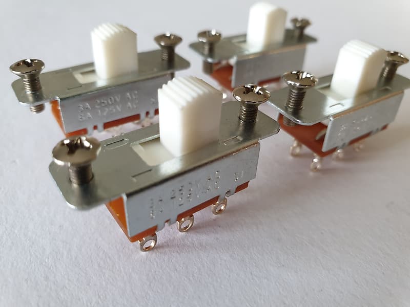 Set of 4 Jaguar guitar slide switches with a white knob | Reverb